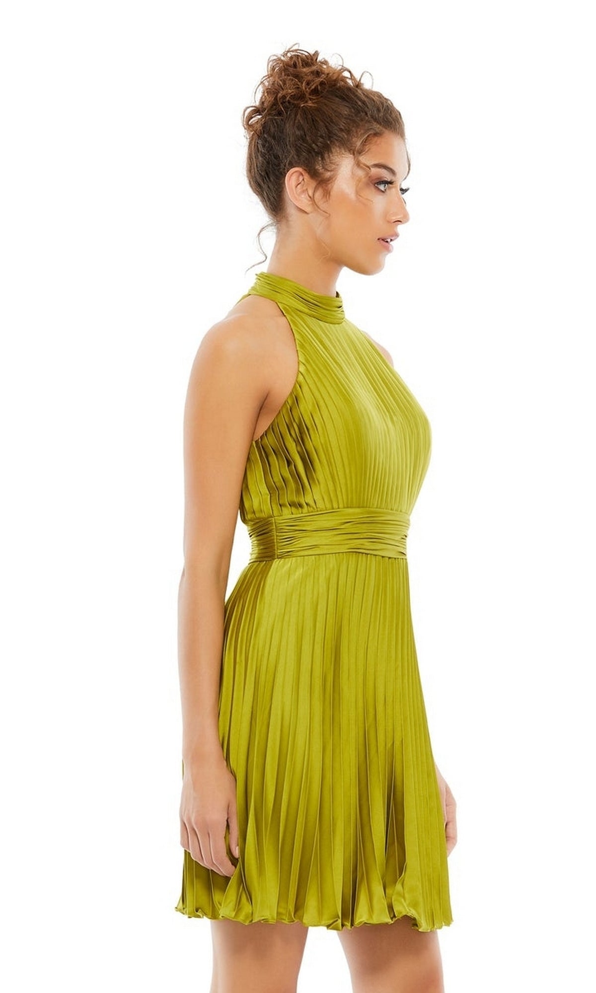 A woman in profile models the Mac Duggal 26645 Short Pleated Hoco Dress, a sleeveless, high-neck lime green homecoming style, set against a white background.